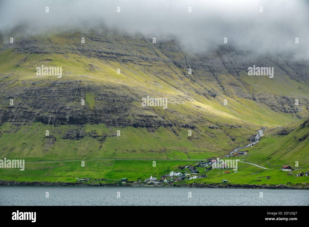 Small village in the hillside under misty sky Stock Photo - Alamy