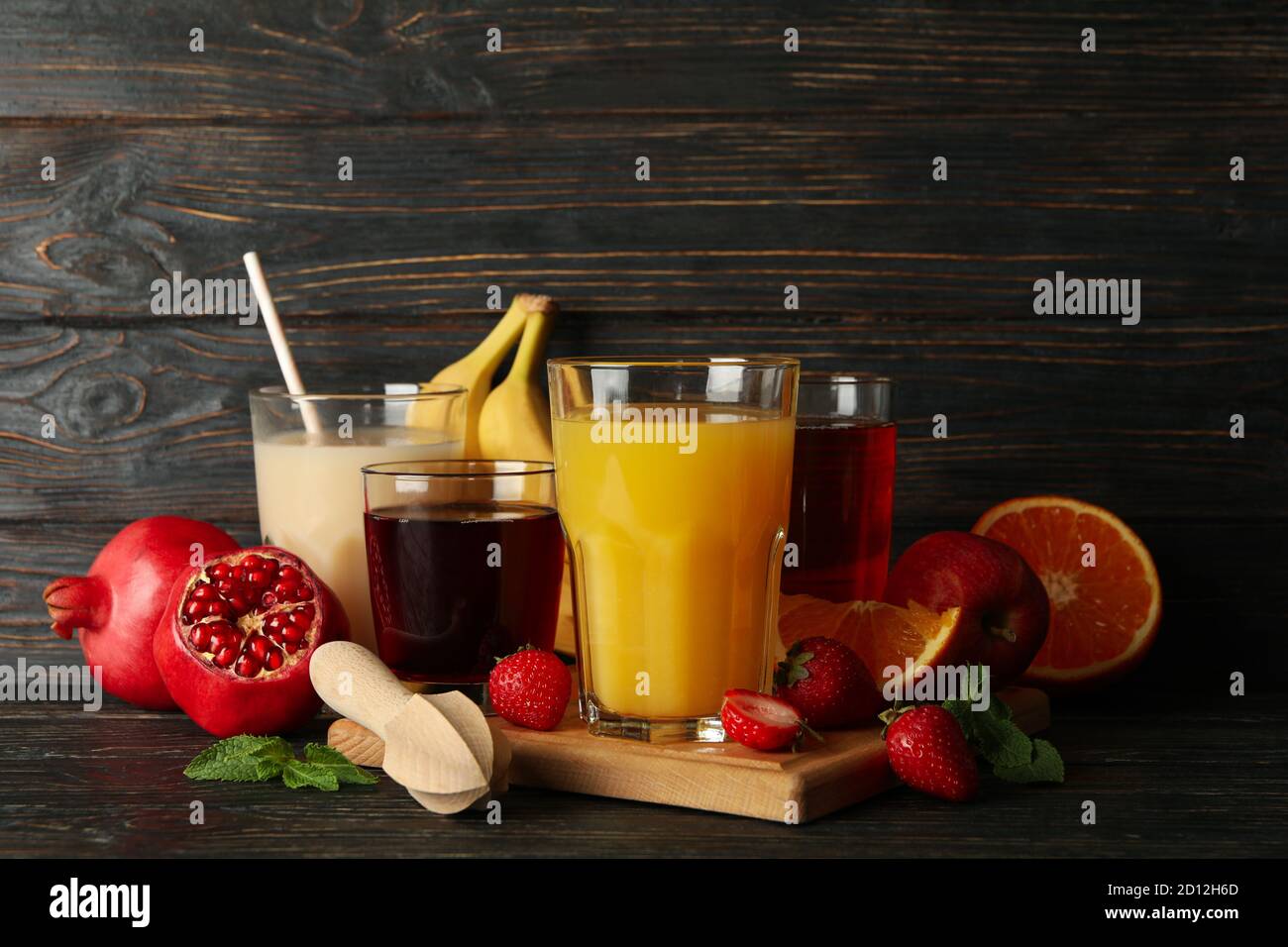 Glasses and jars with different juices on wooden background Stock Photo