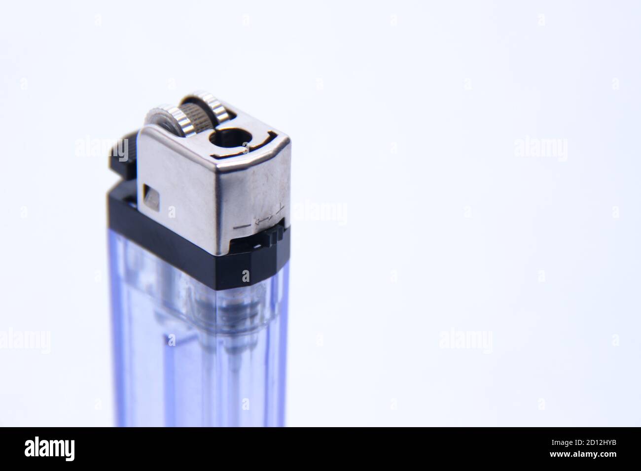 gas lighter with transparent blue container. a tool to burn against a