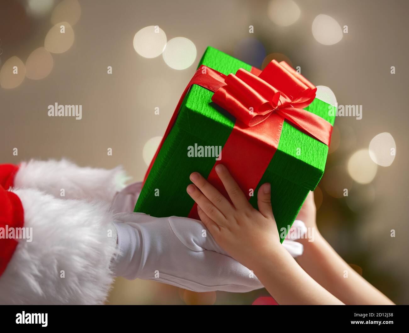 Santa Claus is giving a Christmas gift to child Stock Photo - Alamy