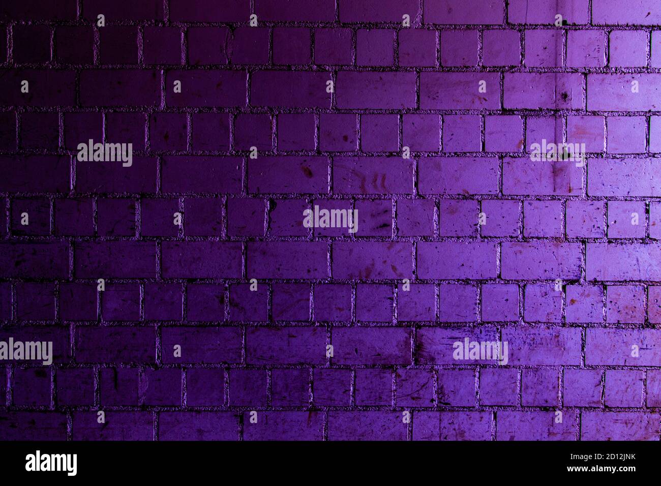 Purple brick wall background with shades of light and dark purple Stock Photo