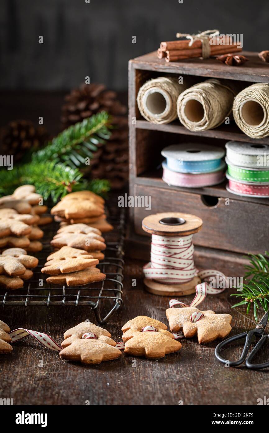 Making rustic cookie chain as decoration for Christmas on wooden table ...