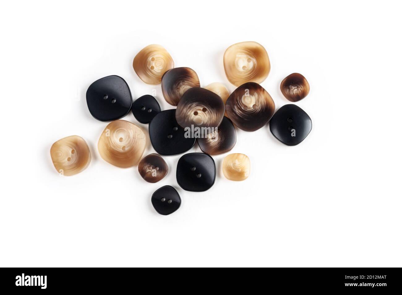 pile, allsorts of brown old gray, beige and brown buttons on a white background. image for sewing and tailor store. space for text Stock Photo