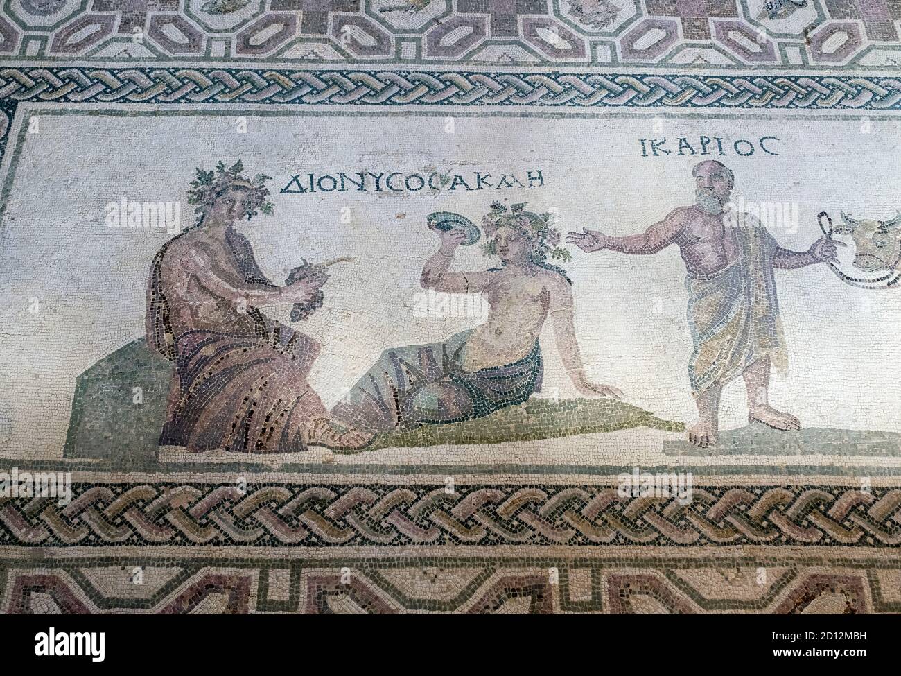 House of Dionysos: Dionysos & Acme are depicted (left) with Icarios holding the reins of an ox-driven double wheeled cart, filled with sacks of wine. Stock Photo