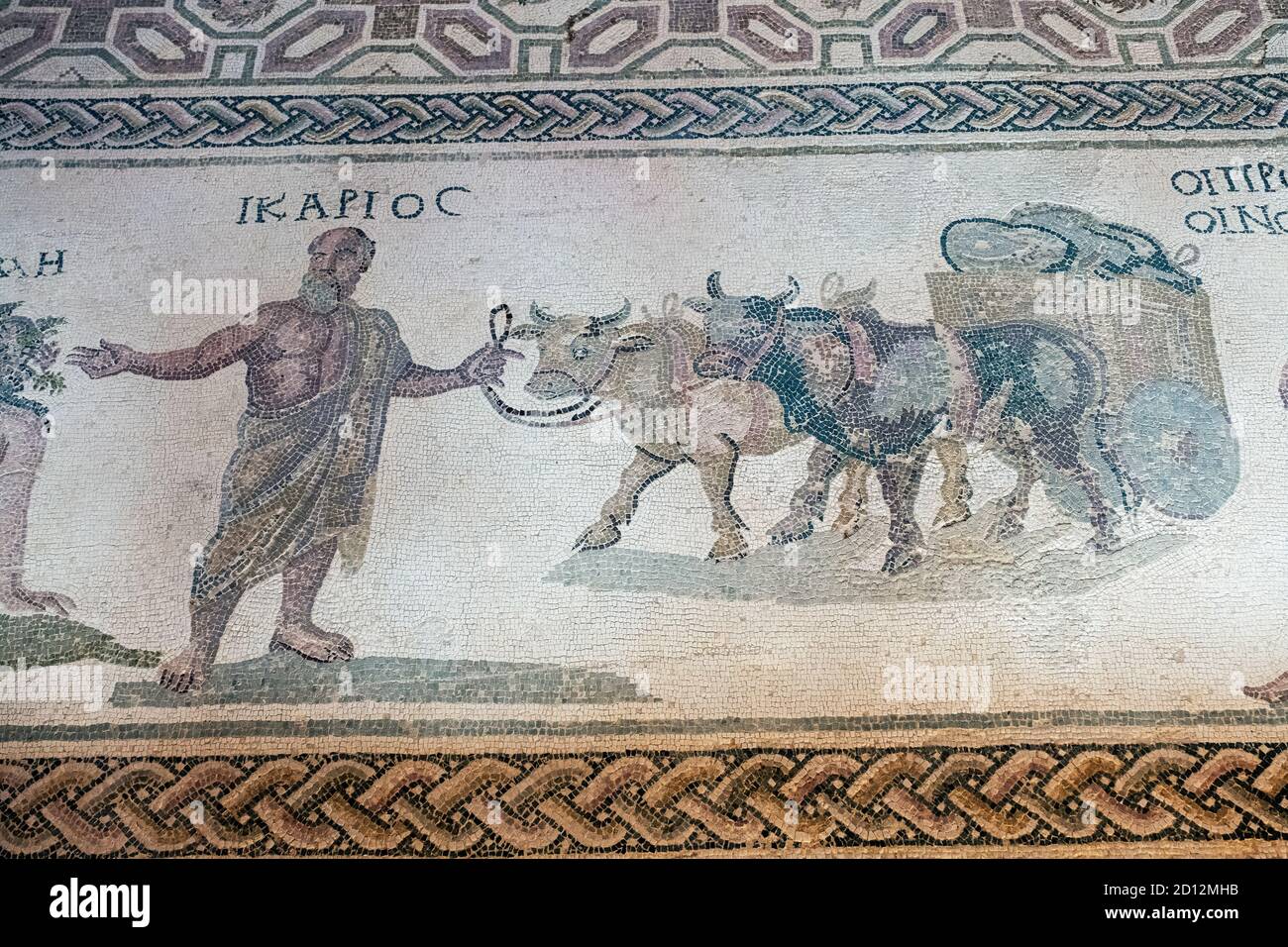 House of Dionysos, Paphos, Cyprus: Icarios depicted holding the reins of an ox-driven double wheeled cart, filled with sacks of wine. Stock Photo