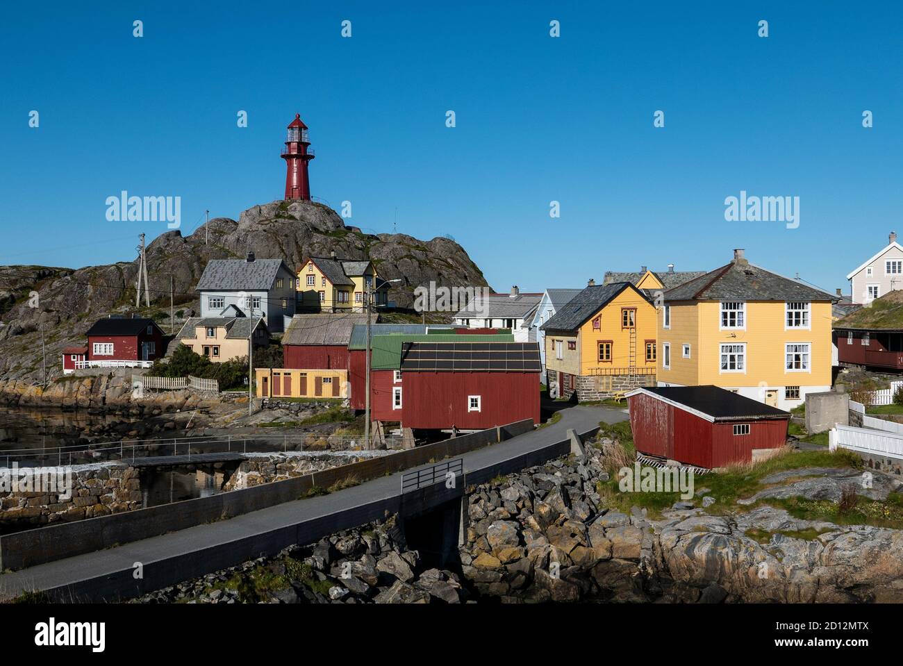 The Ona archipelago consists of the two islands Ona and Husøya. 1867 the famous, red,14,7 metres cast iron lighthouse was built on top of Onakalven. Stock Photo