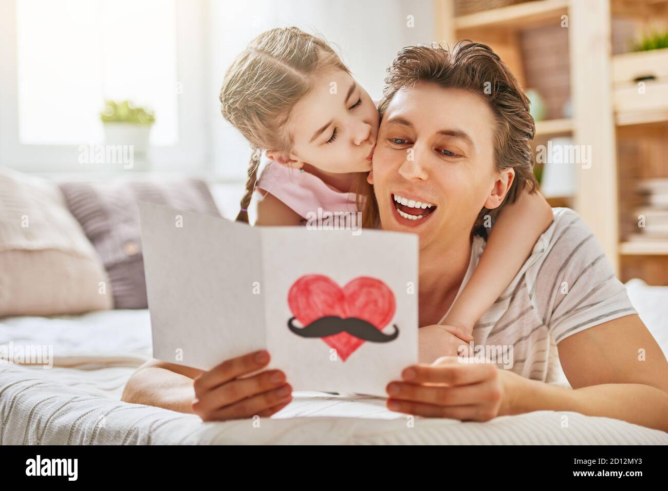 Happy father's day! Child daughter congratulates dad and gives him ...