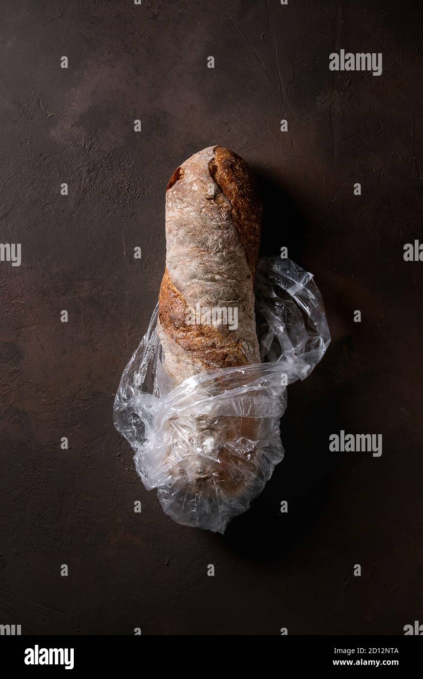 Loaf of fresh baked artisan whole grain ciabatta bread in plastic bag ...