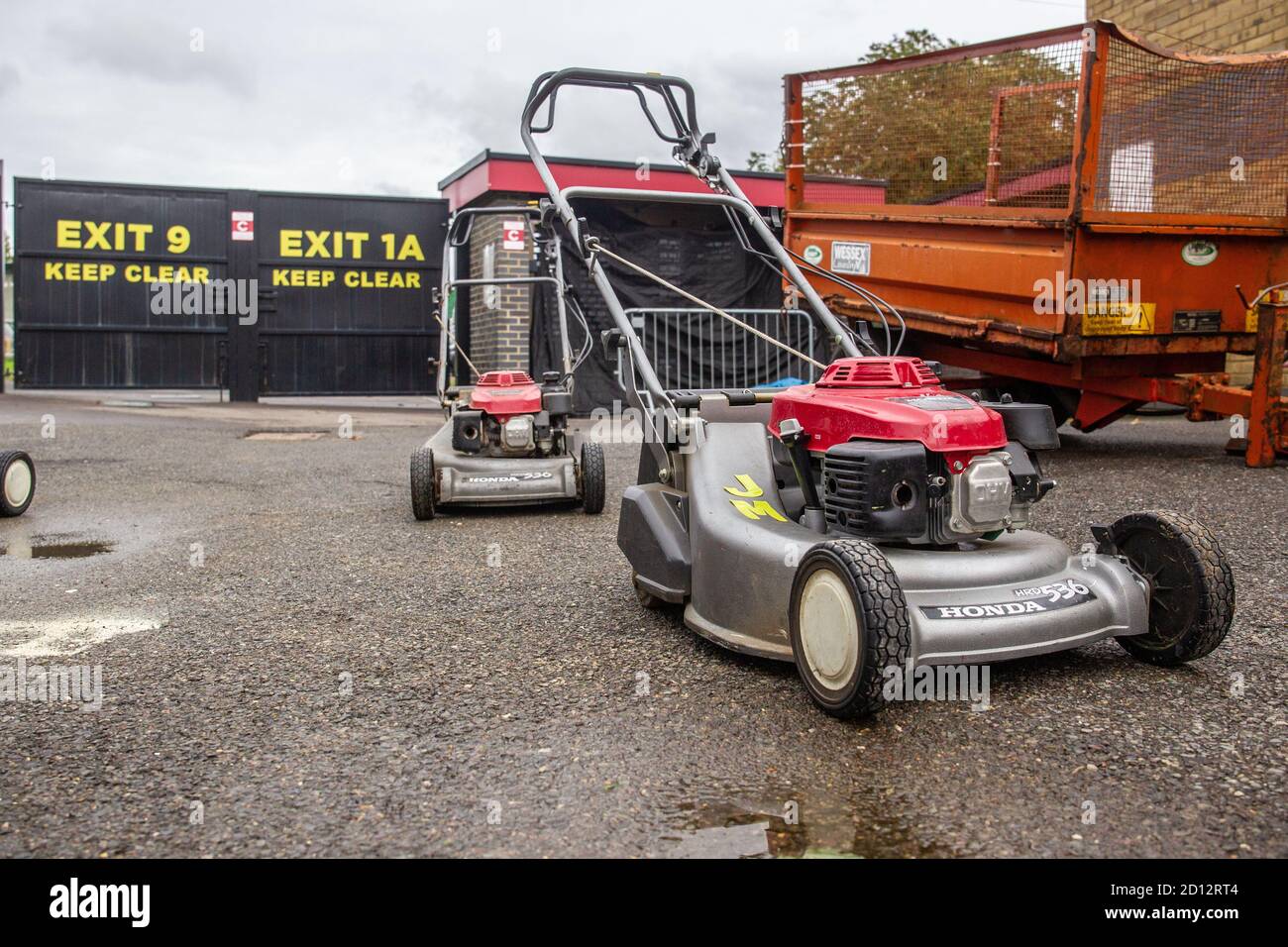 Lawnmowers at football ground set up ready to cut grass on football pitch at Football League Club Stevenage Stock Photo
