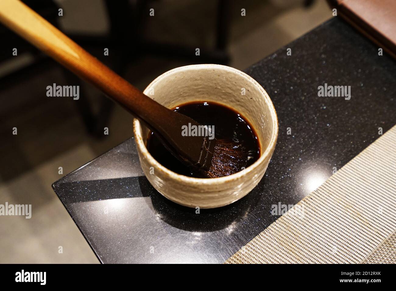Close up wooden brush in sweet soy sauce bowl prepared for Sushi Stock  Photo - Alamy