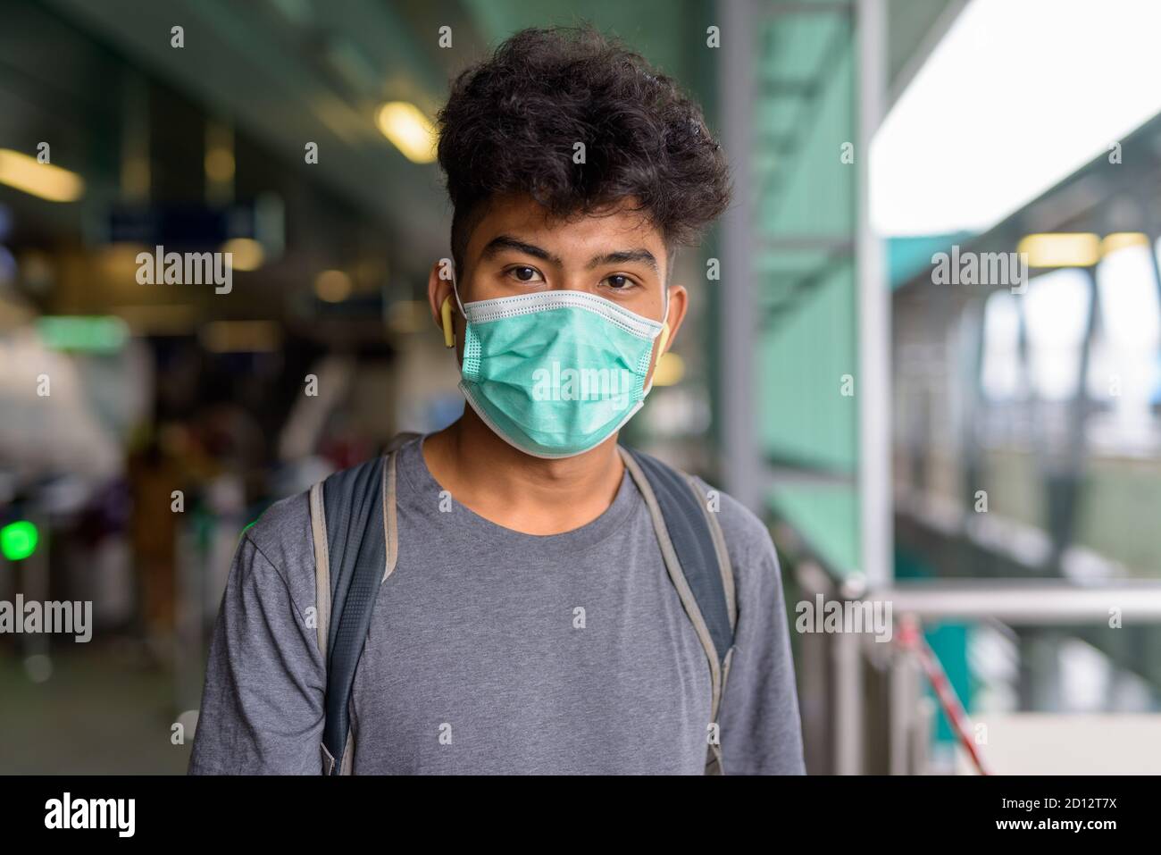Face of young Asian tourist man as backpacker with mask at the sky ...