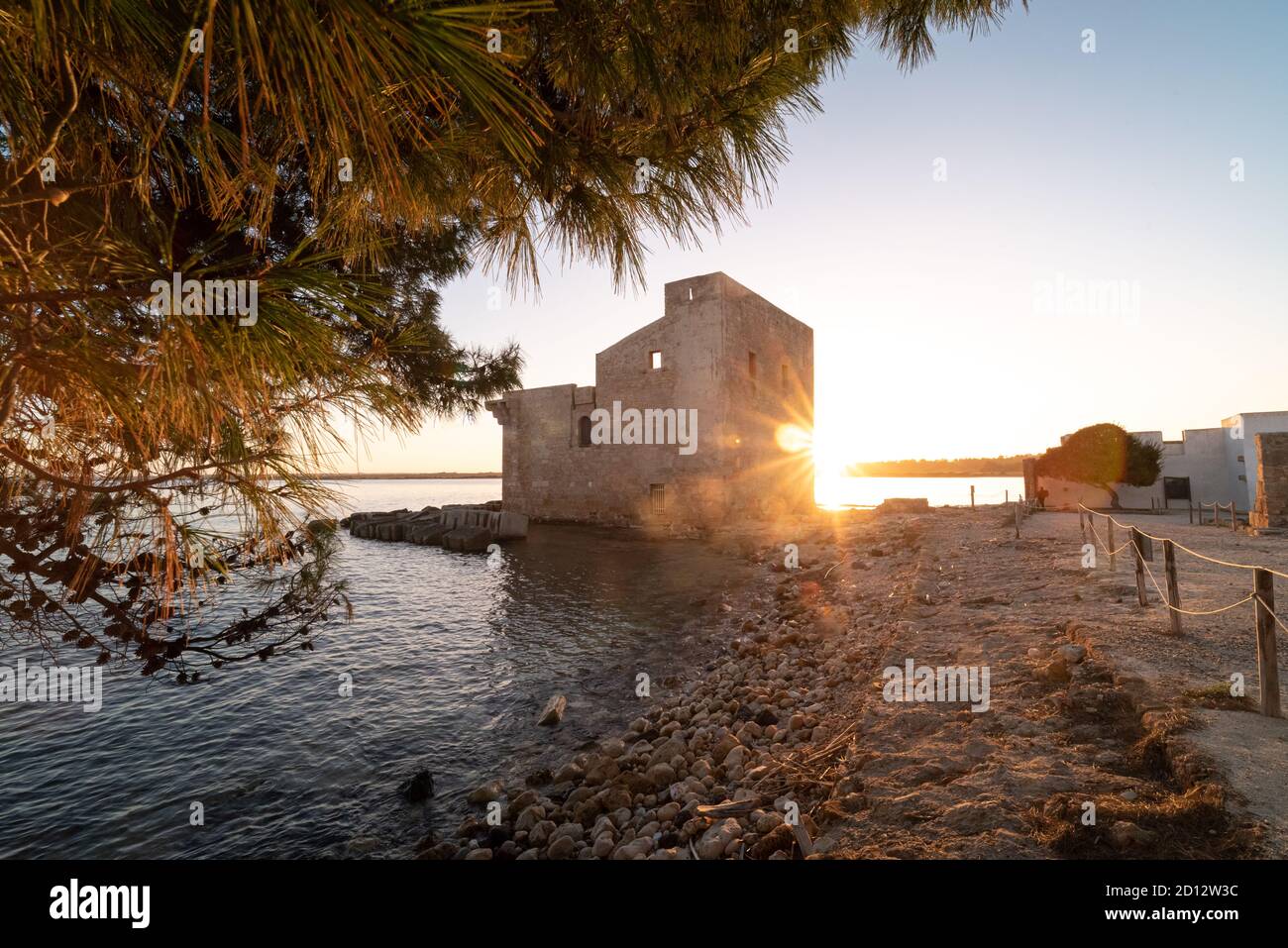 Shot of the ruins of the Torre Sveva at the Tonnara of Vendicari at sunset. The building was a tuna-fishing place and it's now part of a reserve. Stock Photo