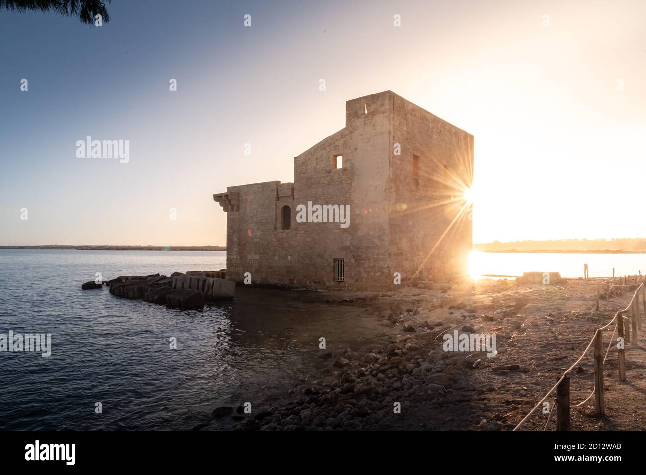 Shot of the ruins of the Torre Sveva at the Tonnara of Vendicari at sunset. The building was a tuna-fishing place and it's now part of a reserve. Stock Photo