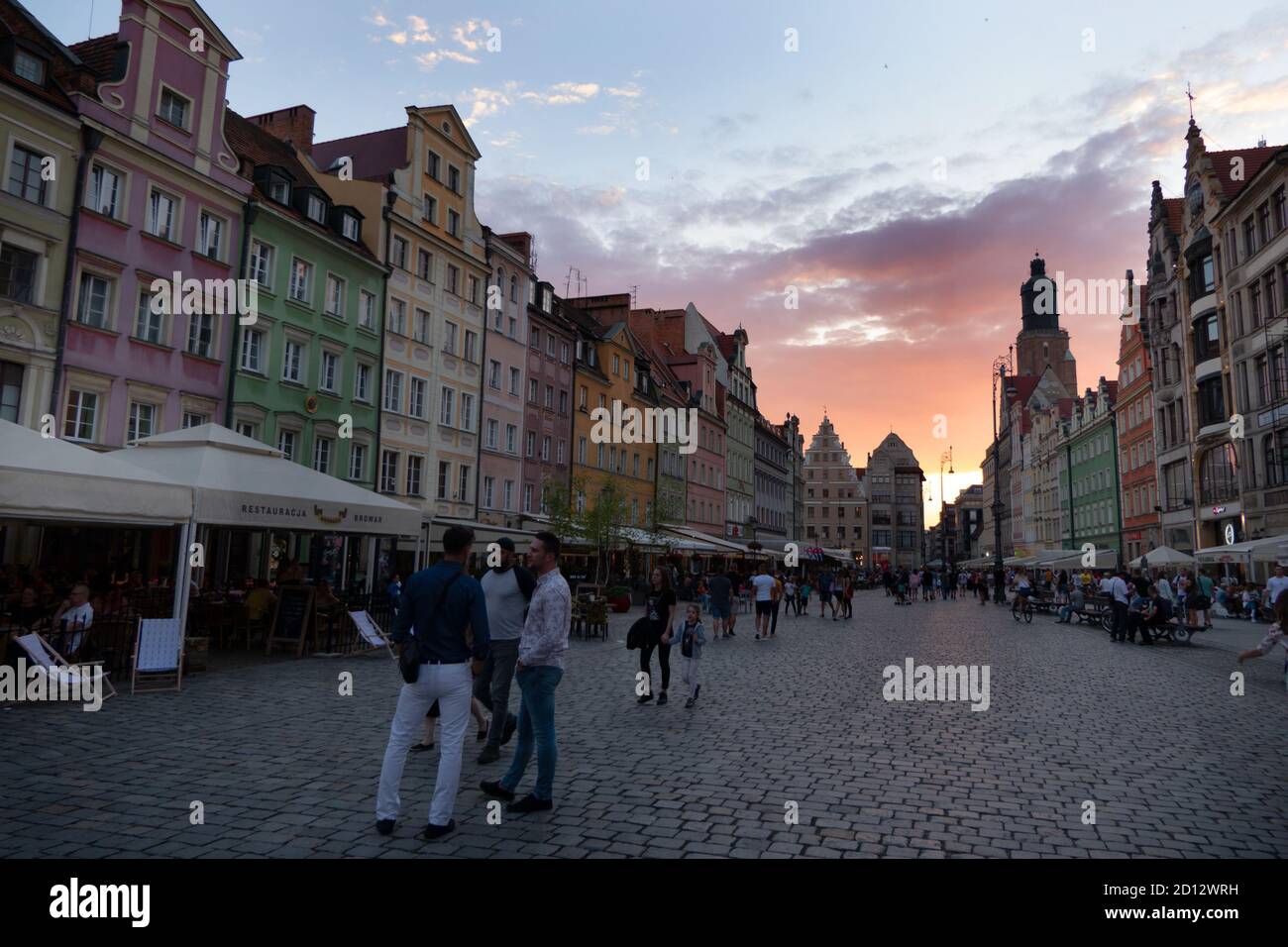 View of Market Square in the old city of Wroclaw (Breslavia), Poland, Europe with tourists walking. Polish landmark with traditional buildings, houses Stock Photo