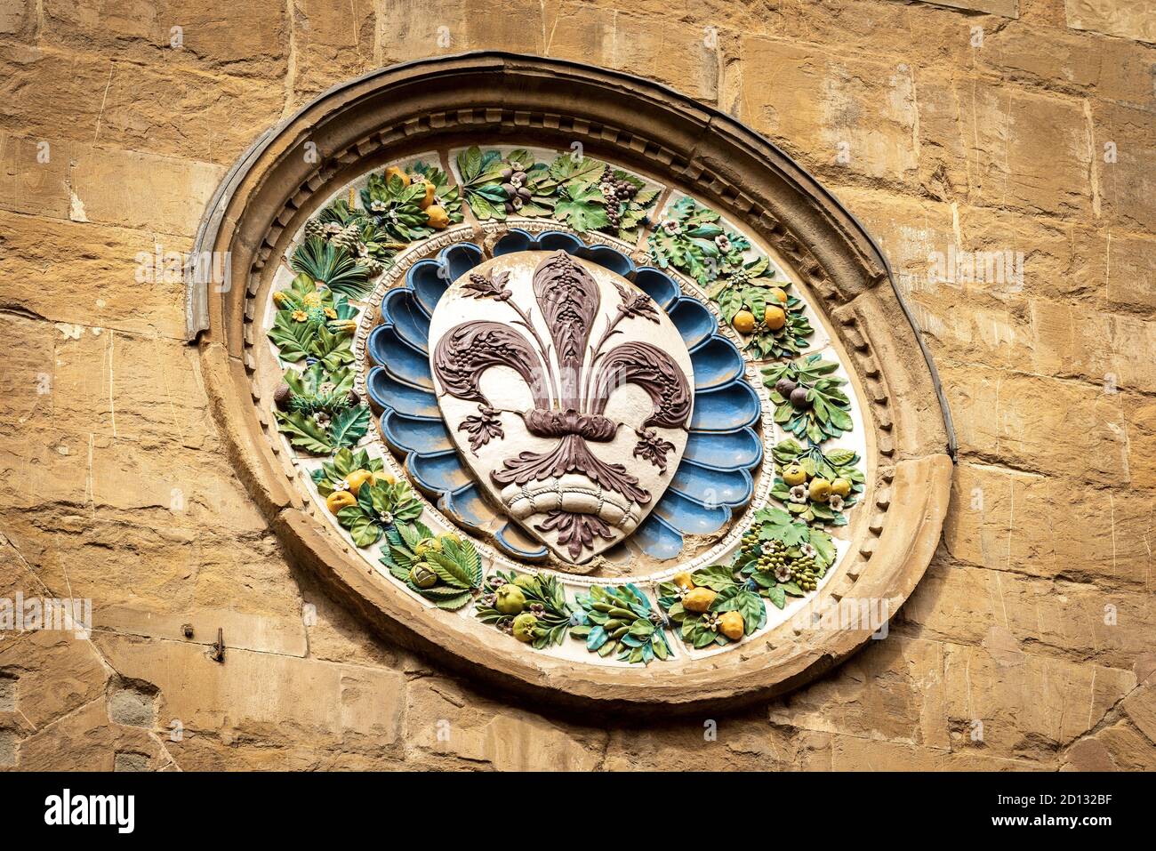 Closeup of the Church of Orsanmichele in gothic style (1337-1380), medallion with the symbol of the city of Florence by the artist Luca della Robbia. Stock Photo