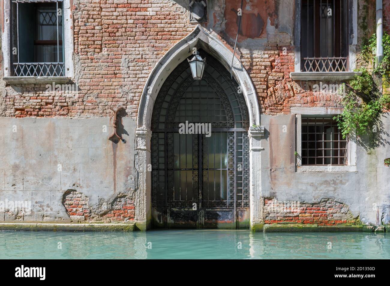 Venice building with old door for boats from Venice canal, Italy Stock Photo