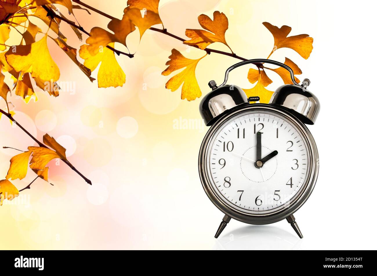 Vintage clock and autumn colors leaves. Fall daylight savings time change concept Stock Photo