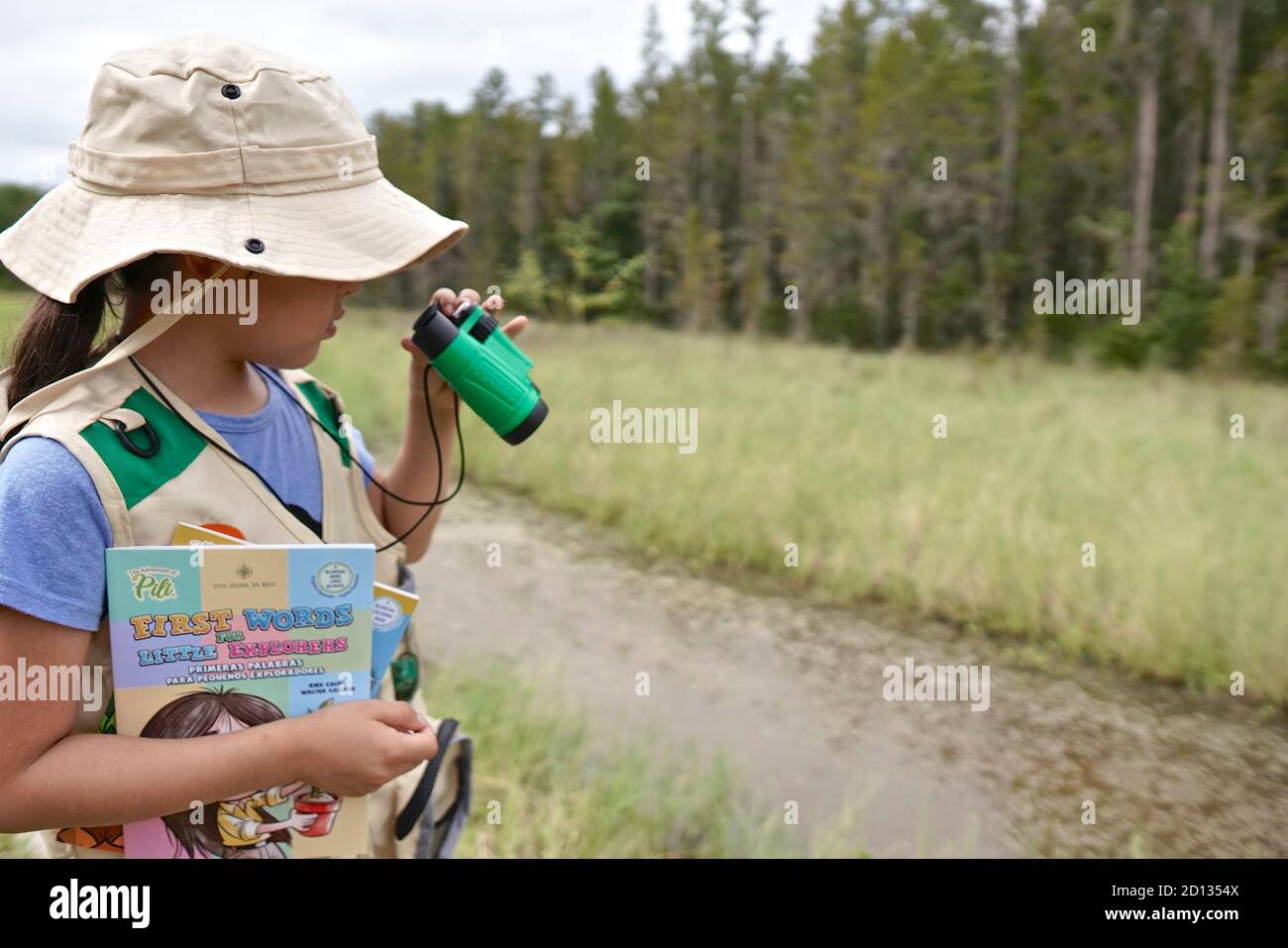 Girl learning about nature in an outdoor class. Stock Photo