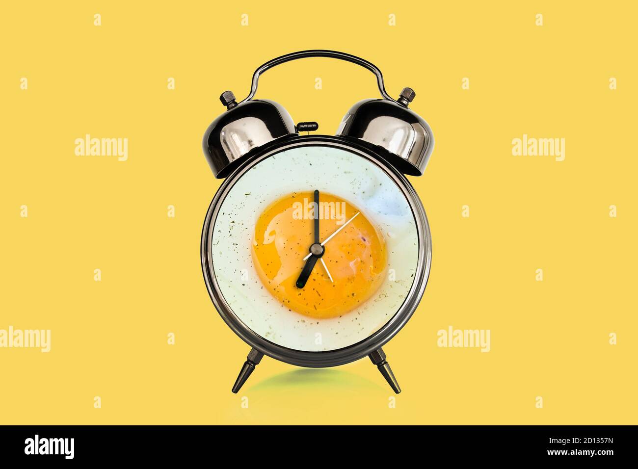 Fried egg and vintage alarm clock collage. Breakfast time concept Stock