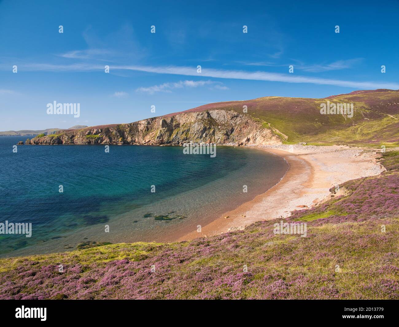 With the headland of Burki Taing in the distance, the sandy beach at Muckle Ayre on the south coast of Muckle Roe,  Shetland, Scotland, UK Stock Photo