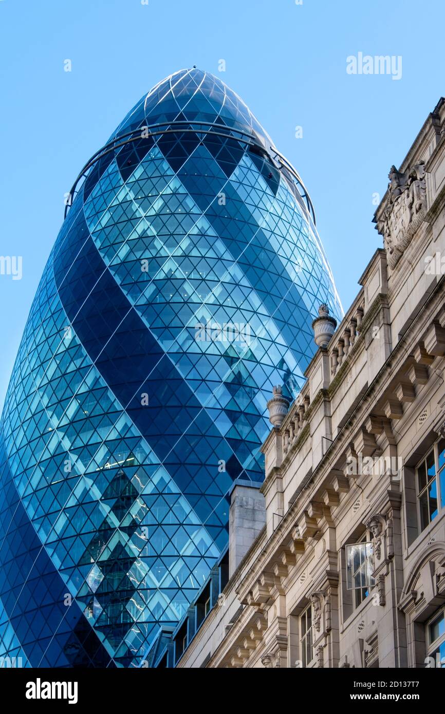 The Gherkin building (30 St Mary Axe) & neoclassical buildings on St. Helen's Place, City of London, UK Stock Photo