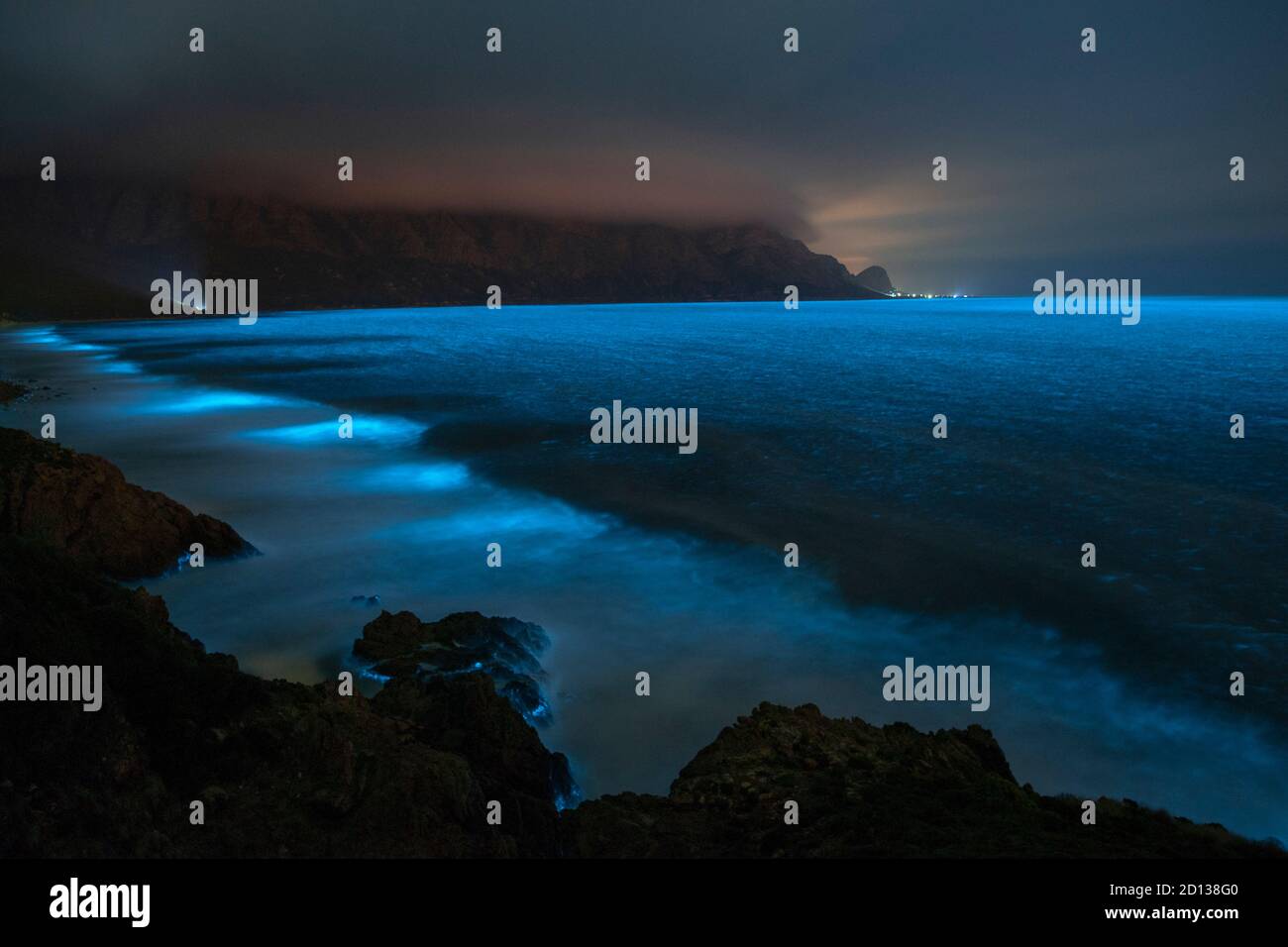 Bioluminescent phytoplankton illuminating the ocean along the coast at the Kogelberg Biosphere Reserve near Cape Town, South Africa. Stock Photo