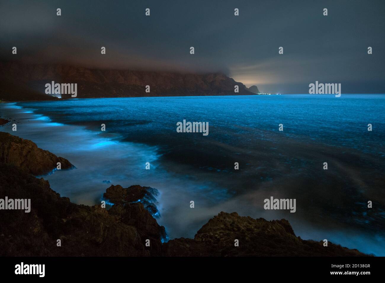 Bioluminescent phytoplankton illuminating the ocean along the coast at the Kogelberg Biosphere Reserve near Cape Town, South Africa. Stock Photo