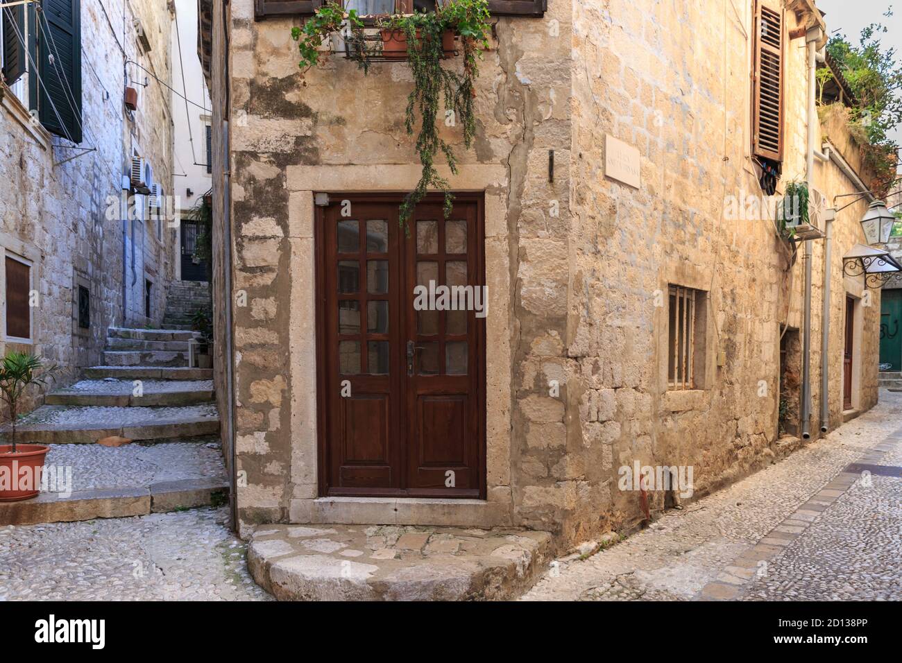 Cobble stone street corner with historic stone buildings in the Old Town, Dubrovnik, Croatia Stock Photo