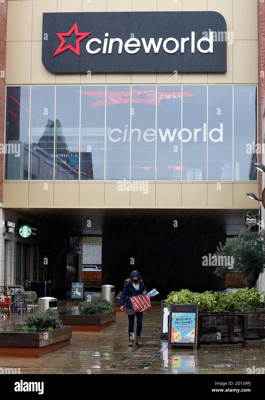 Loughborough, Leicestershire, UK. 5th October 2020. A woman walks past a Cineworld cinema after it was announced that because of continuing disruption from the coronavirus pandemic its screens would close until next year. Credit Darren Staples/Alamy Live News. Stock Photo