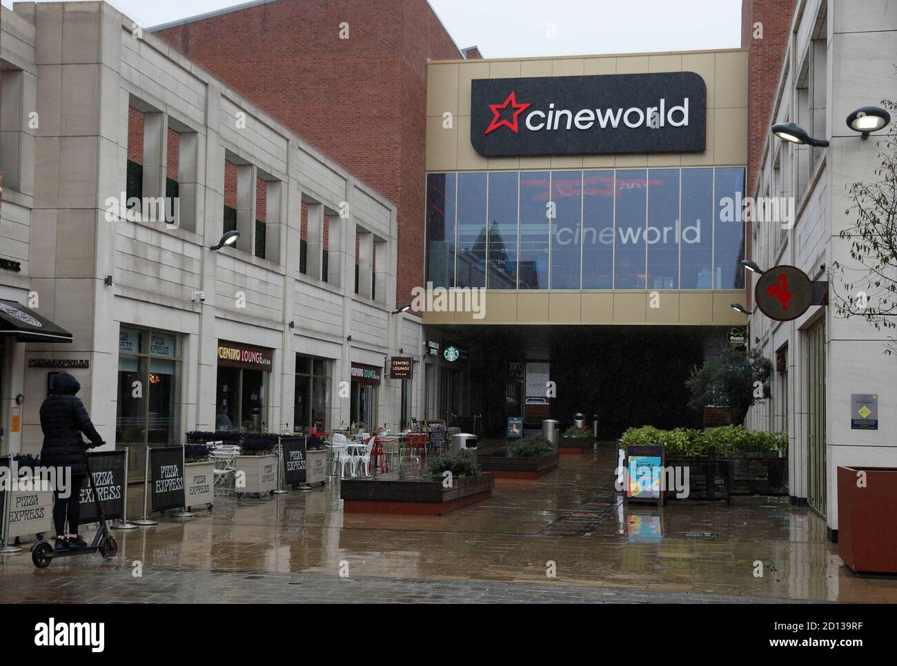 Loughborough, Leicestershire, UK. 5th October 2020. A woman scoots past a Cineworld cinema after it was announced that because of continuing disruption from the coronavirus pandemic its screens would close until next year. Credit Darren Staples/Alamy Live News. Stock Photo