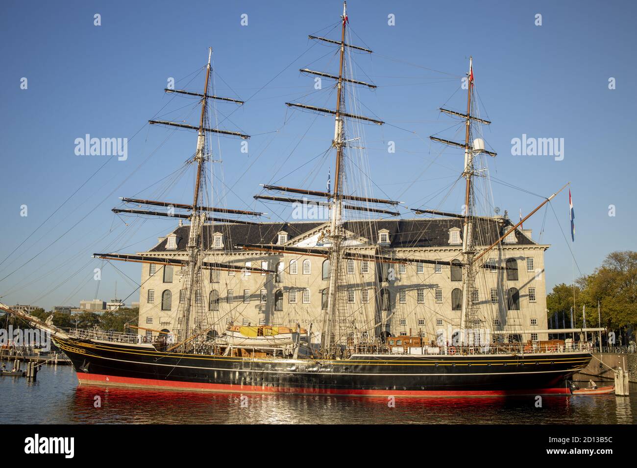 AMSTERDAM, NETHERLANDS - Sep 22, 2020: Closeup of historic seafarer sail ship in front of open air maritime Scheepvaart museum against a clear blue sk Stock Photo