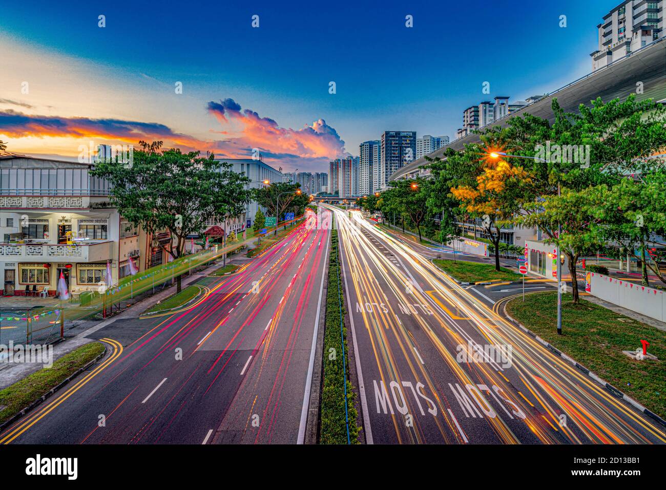 Long exposure of cars light trails in Singapore city against residential and iconic urban and heritage architecture Stock Photo
