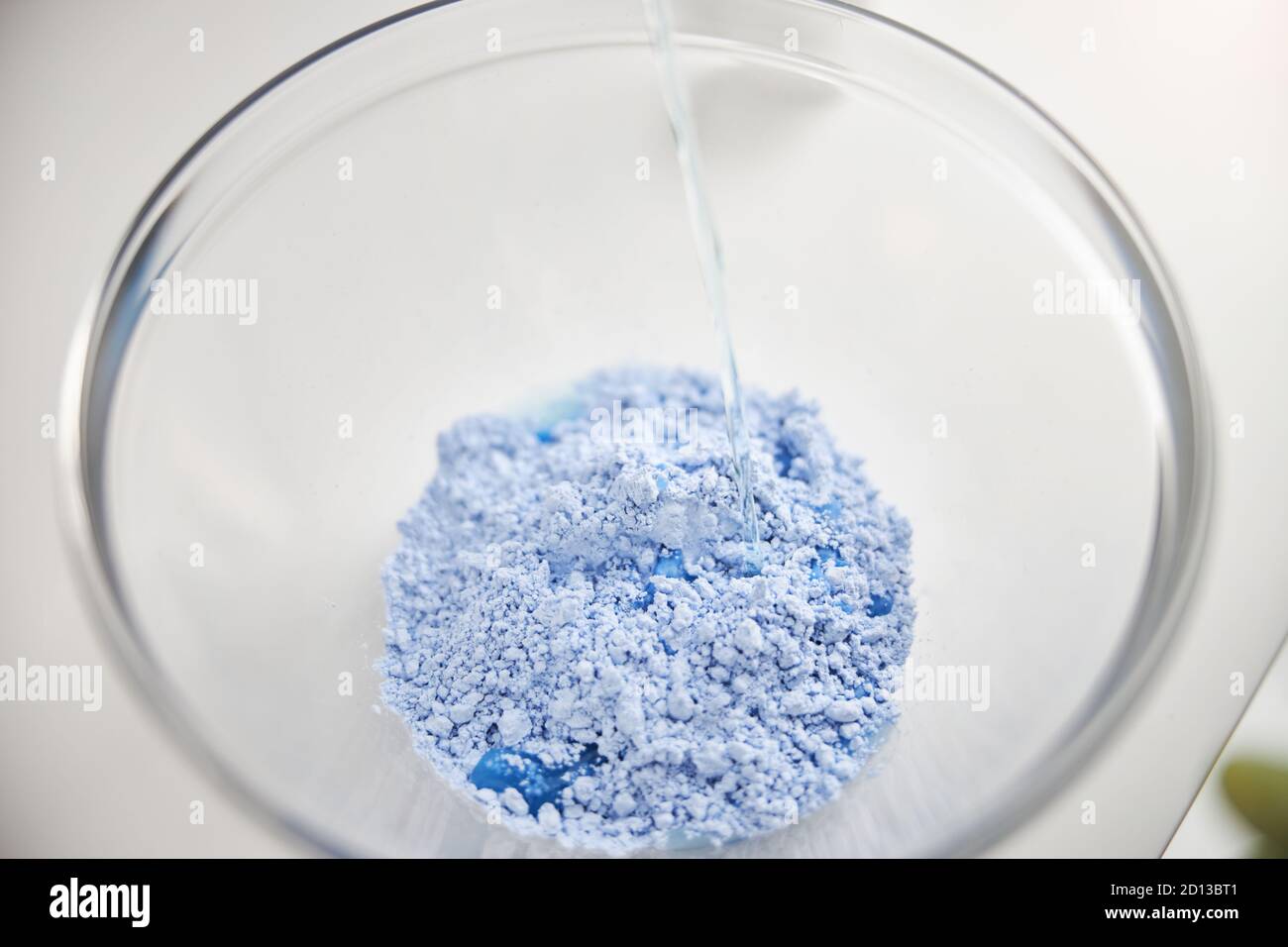 Transparent bowl with light-blue powder at spa Stock Photo