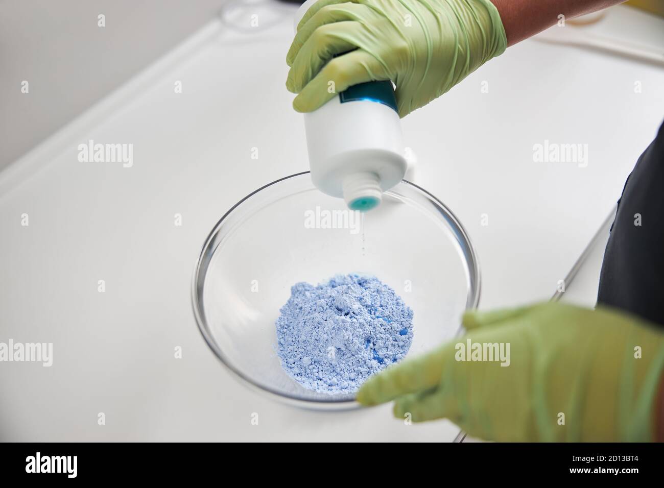 Qualified spa worker mixing components for a cream Stock Photo