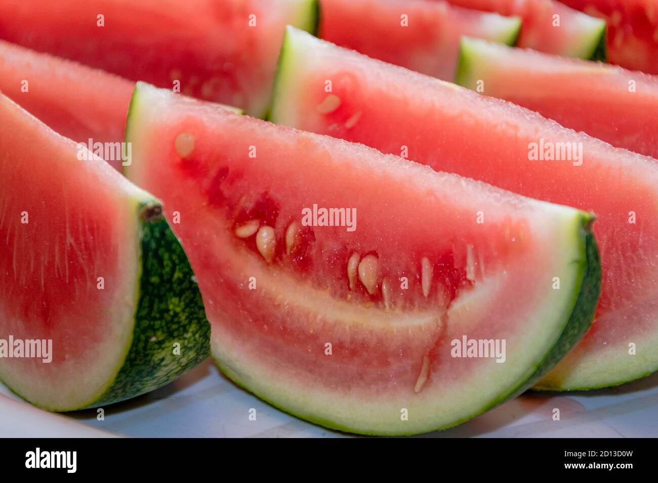 Homegrown small watery and tasty sliced into sections watermelon. Stock Photo