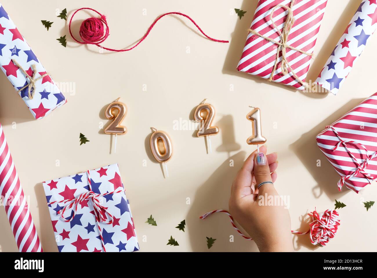 New Year background with gifts and candles figures 2021. Stock Photo