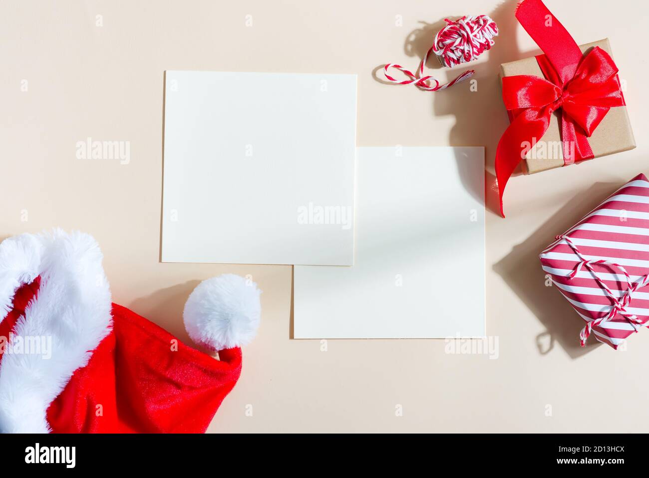 Christmas greeting card with red hat and gifts boxes. Stock Photo
