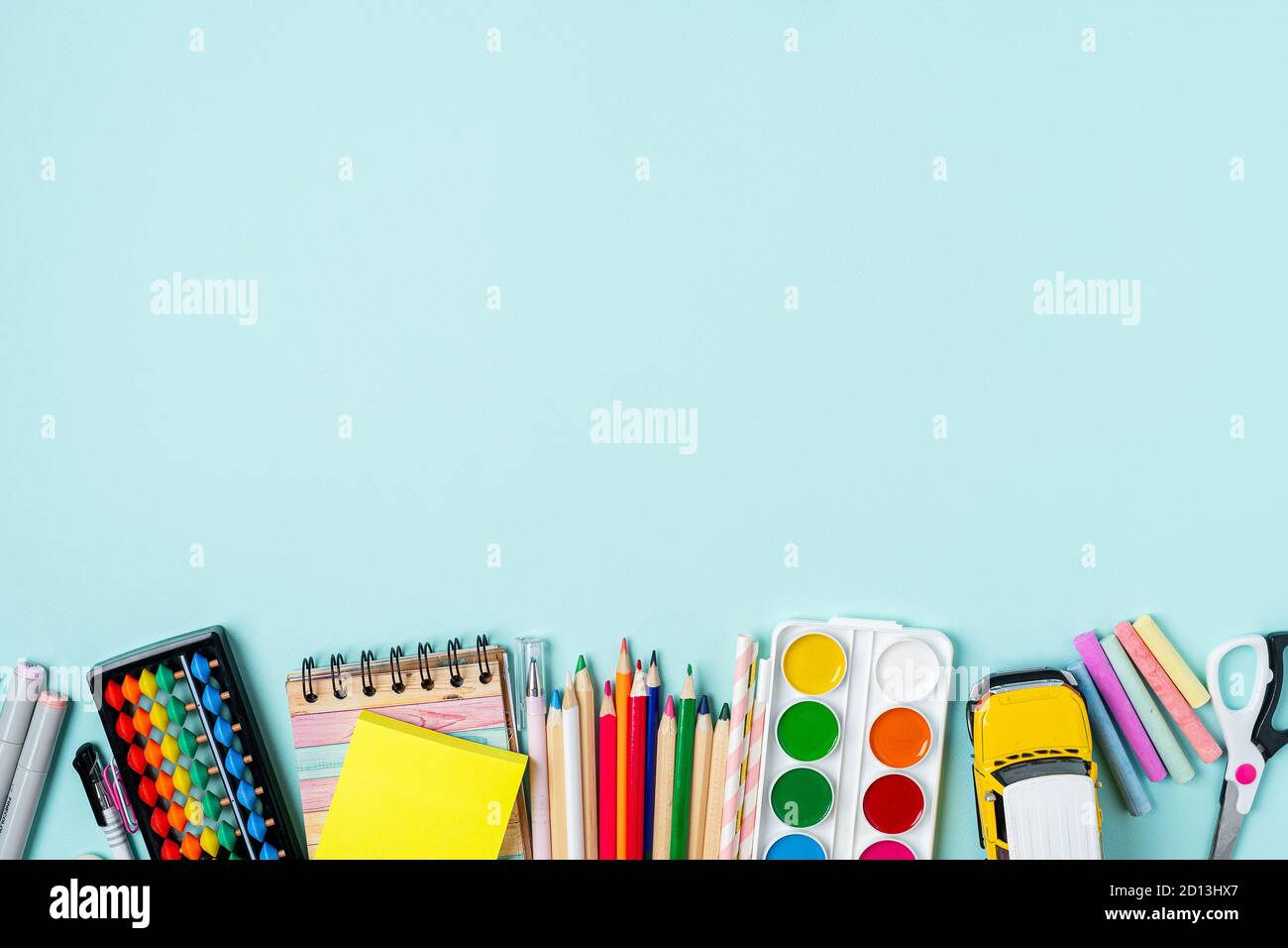 Flat lay of modern bright blue office desktop with school supplies on ...