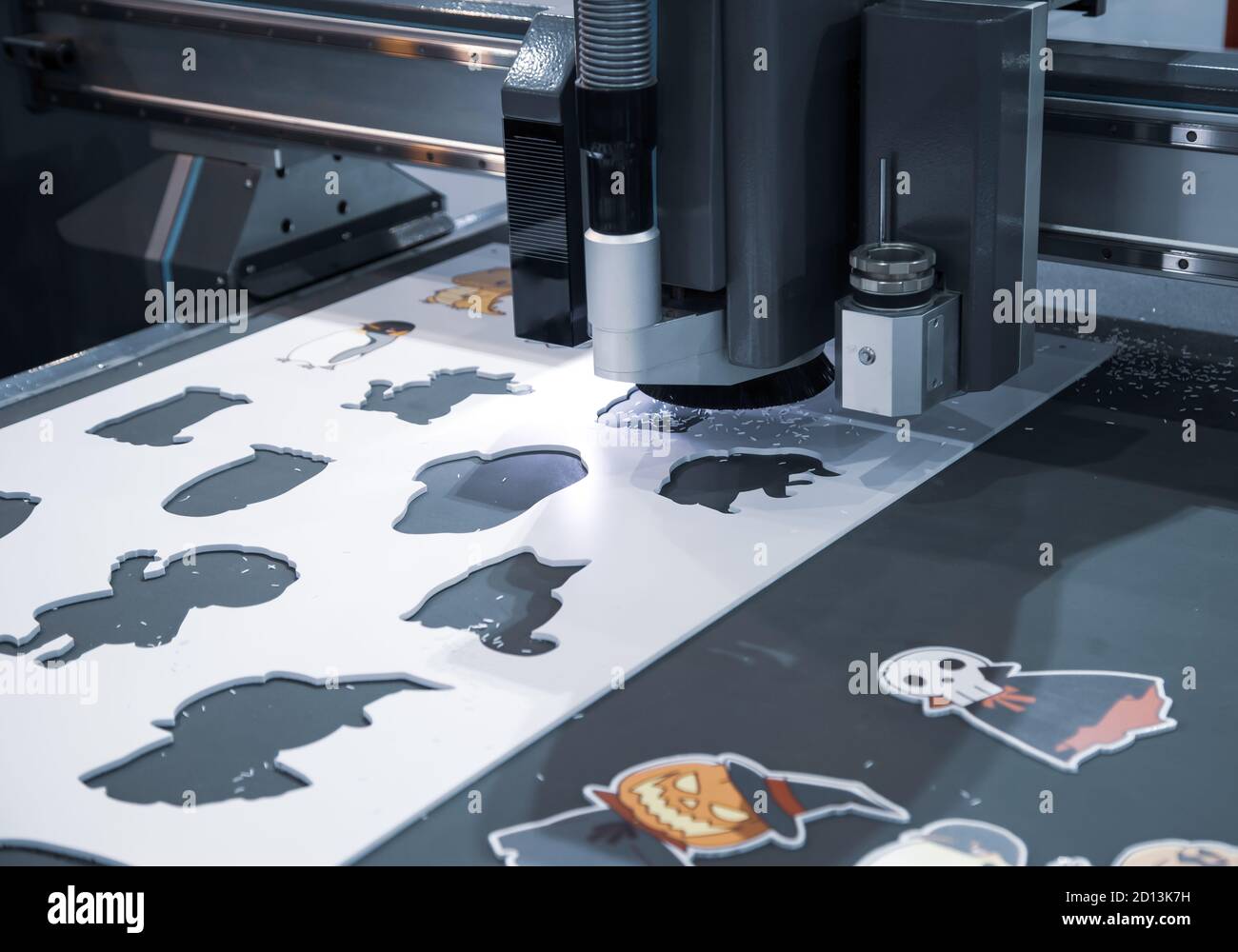 Digital cutting machine cutting cartoon graphic design on ABS plastic sheet  Stock Photo - Alamy