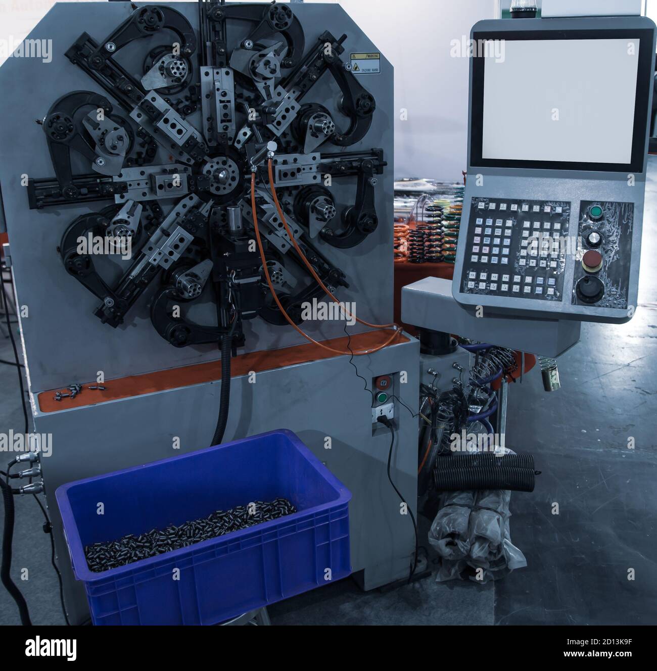 Automatic CNC spring coiling machine. Industrial machinery Stock Photo