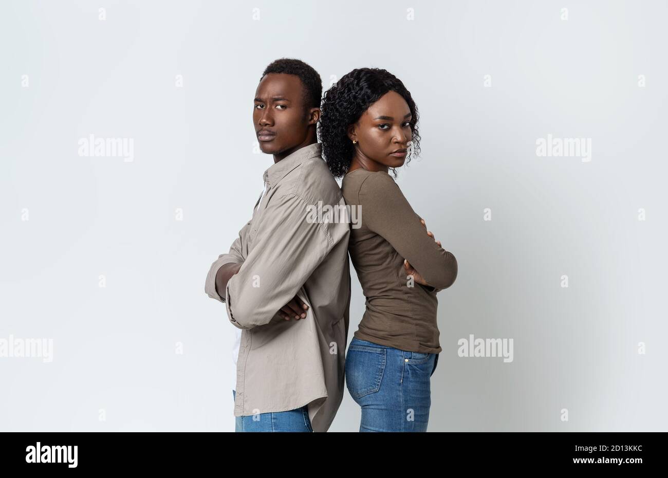 Sad african american man and woman staying back to back Stock Photo - Alamy