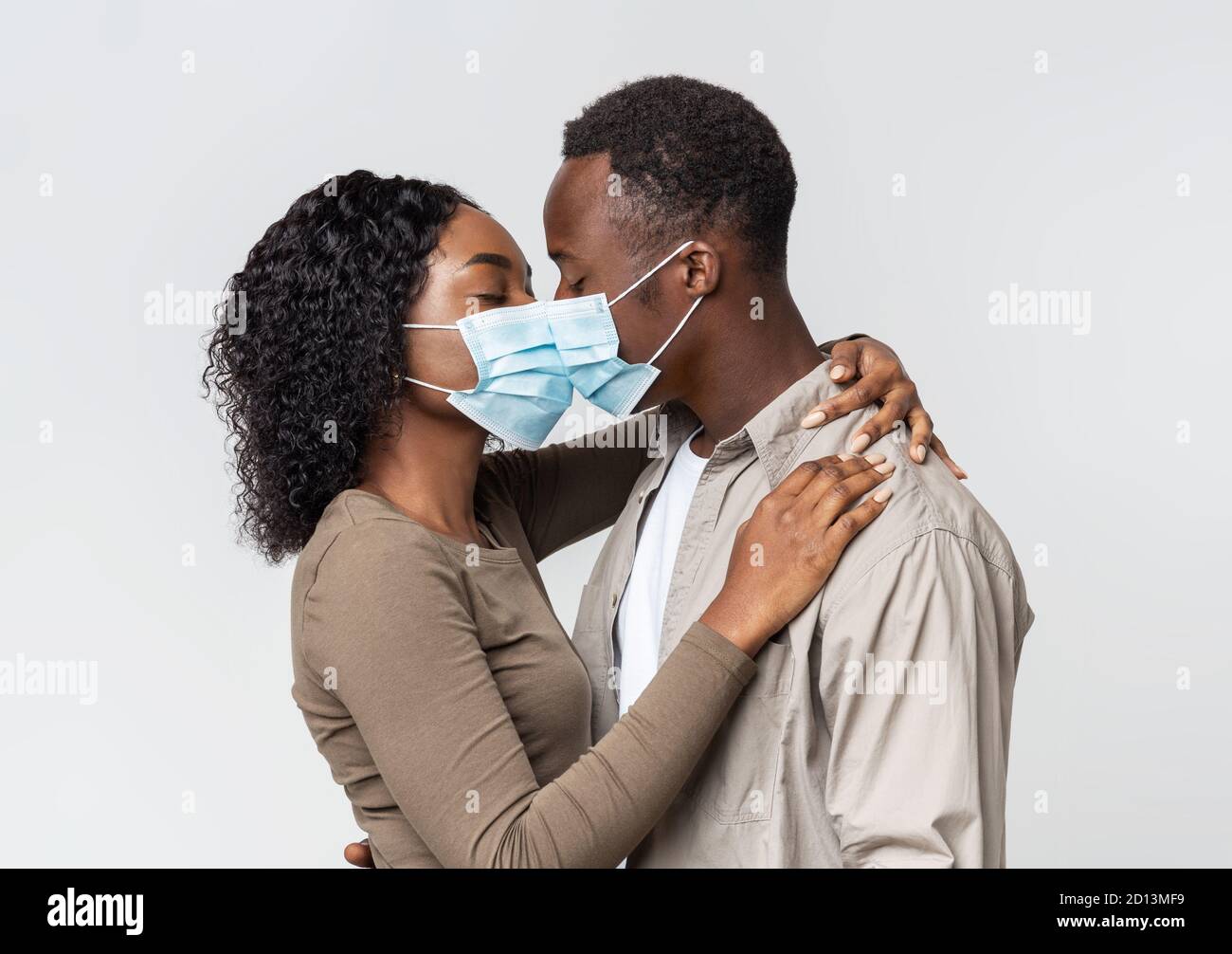 Romantic african couple in face masks kissing over grey Stock Photo Alamy