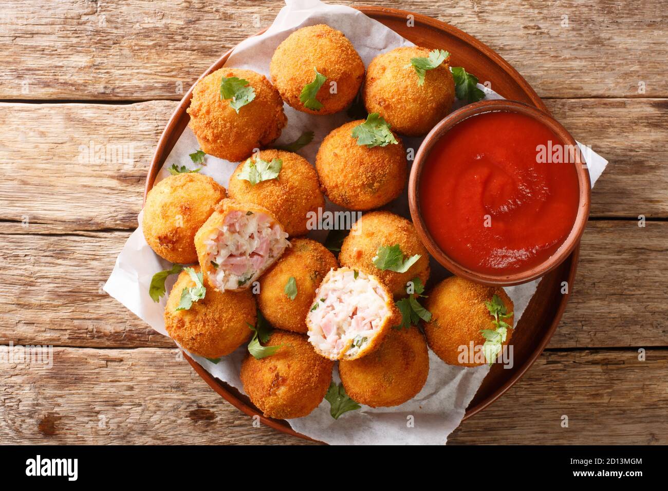 Hot fried sauerkraut balls with ham and cheese closeup in a plate on