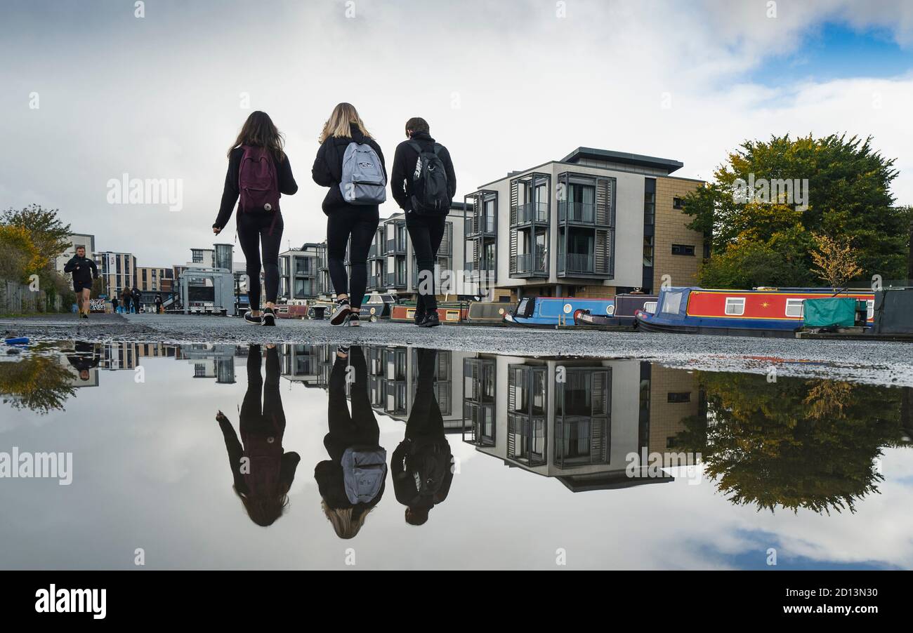 Edinburgh, Scotland, UK. 5 October, 2020. After a weekend of heavy rain from Storm Alex , members of the public were out on the towpath of the Union Canal at Fountainbridge today enjoying some dry, calm weather. Pictured; Students from Boroughmuir High School on their lunch break.  Iain Masterton/Alamy Live News Stock Photo