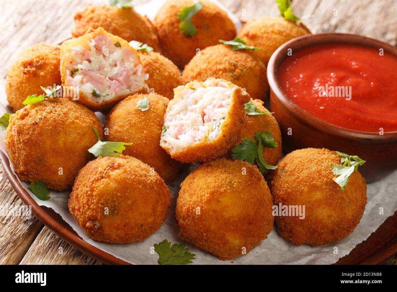 Hot fried sauerkraut balls with ham and cheese closeup in a plate on