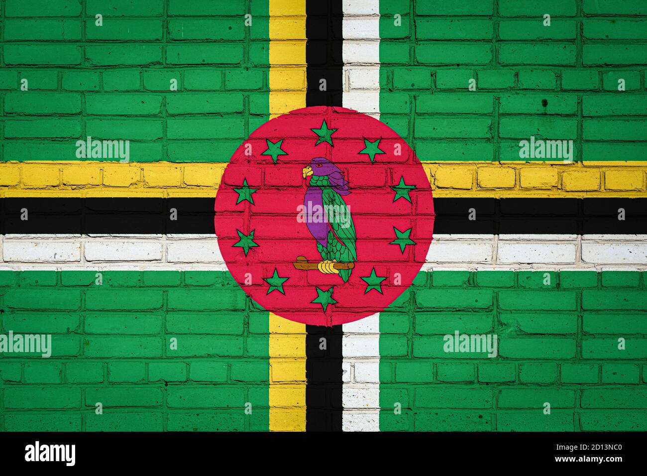 National flag of Dominica depicting in paint colors on an old brick ...