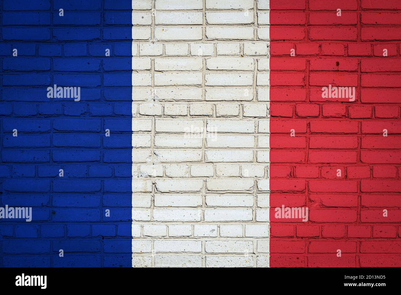 National flag of France depicting in paint colors on an old brick wall ...