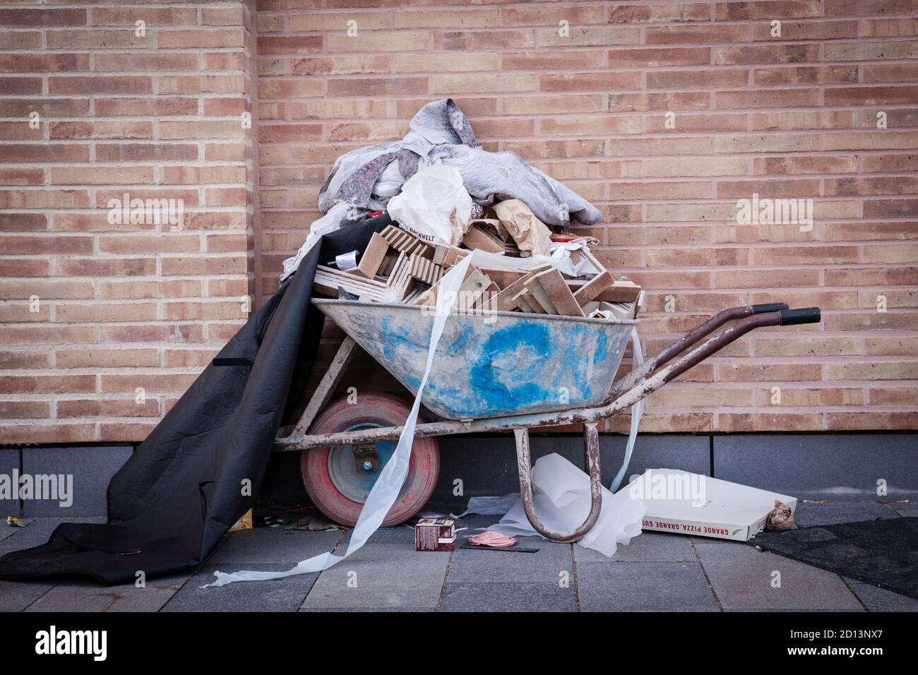 overflowing wheelbarrow with tiles and waste, Cologne,  Germany.  uebervolle Schubkarre mit Fliesen und Abfall, Koeln, Deutschland. Stock Photo