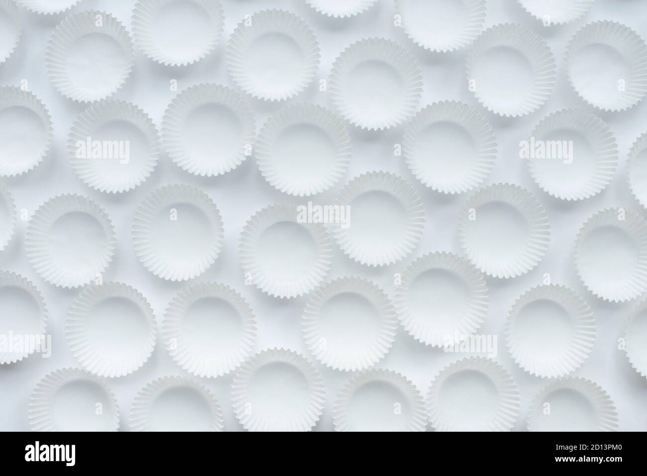 Empty paper cupcakes molds on white background Stock Photo