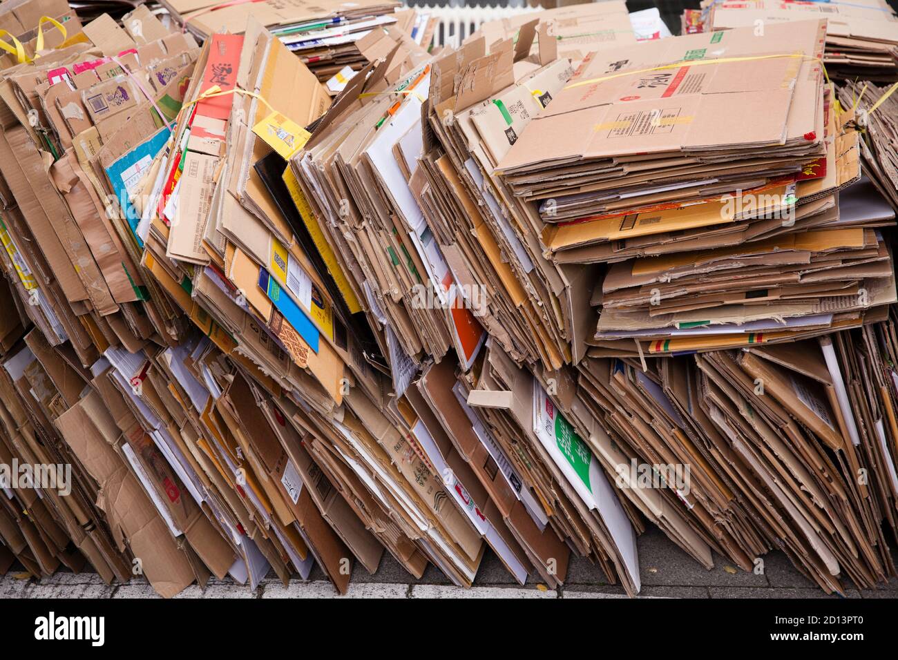 disassembled and bundled cardboard boxes lie on the sidewalk for disposal, Cologne, Germany.  zerlegte und gebuendelte Pappkartons liegen zum Abtransp Stock Photo